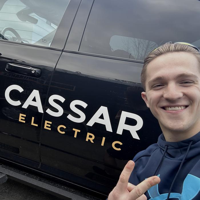 Adam beside a Cassar Electric truck